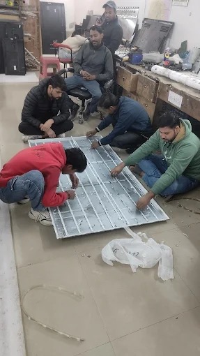 Technician repairing an LED TV at a customer's home in Delhi
