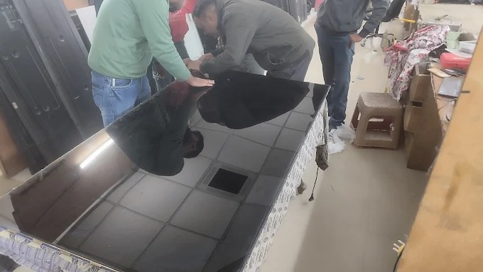 Technician testing audio system on a customer's TV