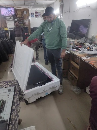 Technician repairing Smart TV software issues at a customer's home